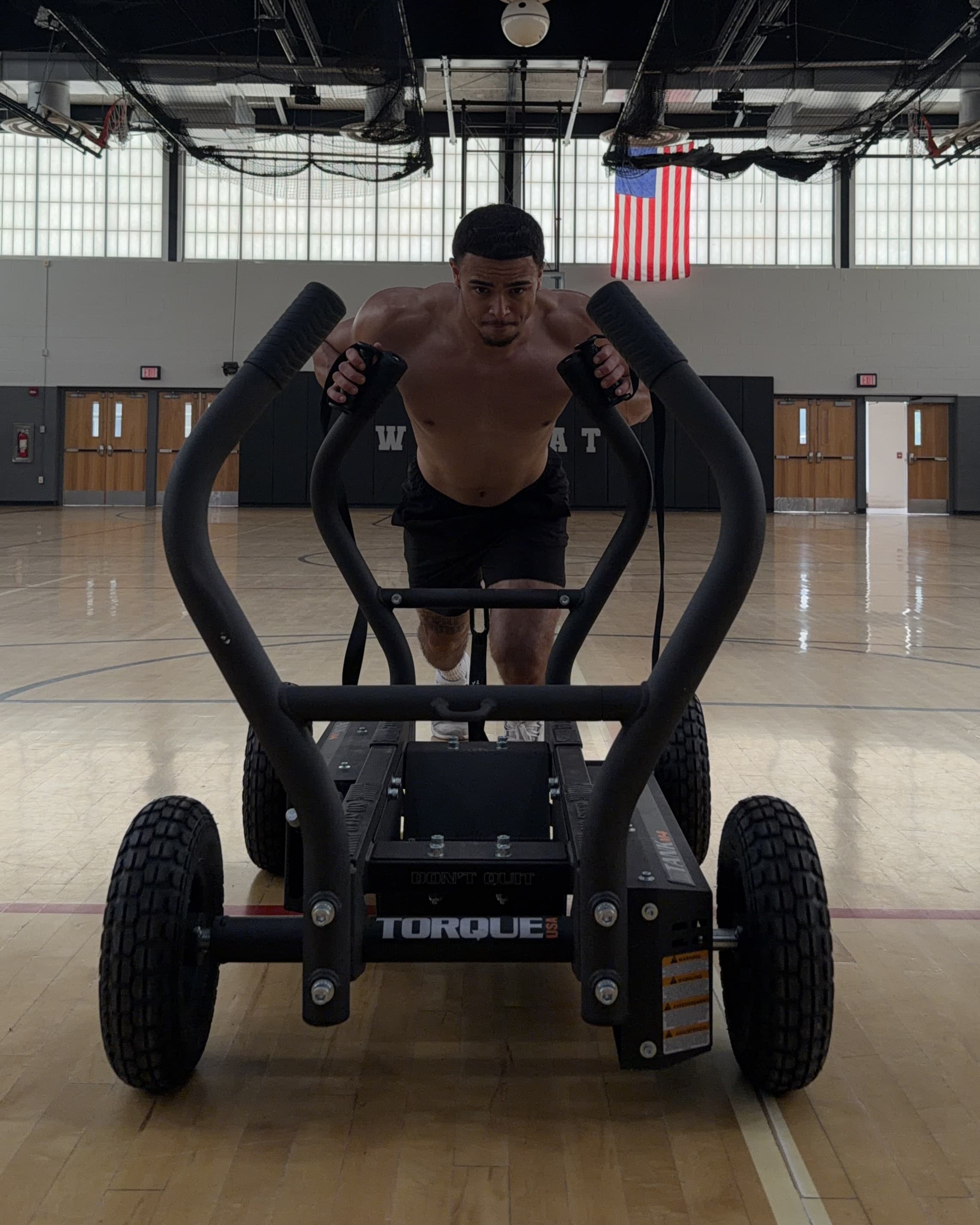 Kai Tranchant pushing a Torque sled in the gym